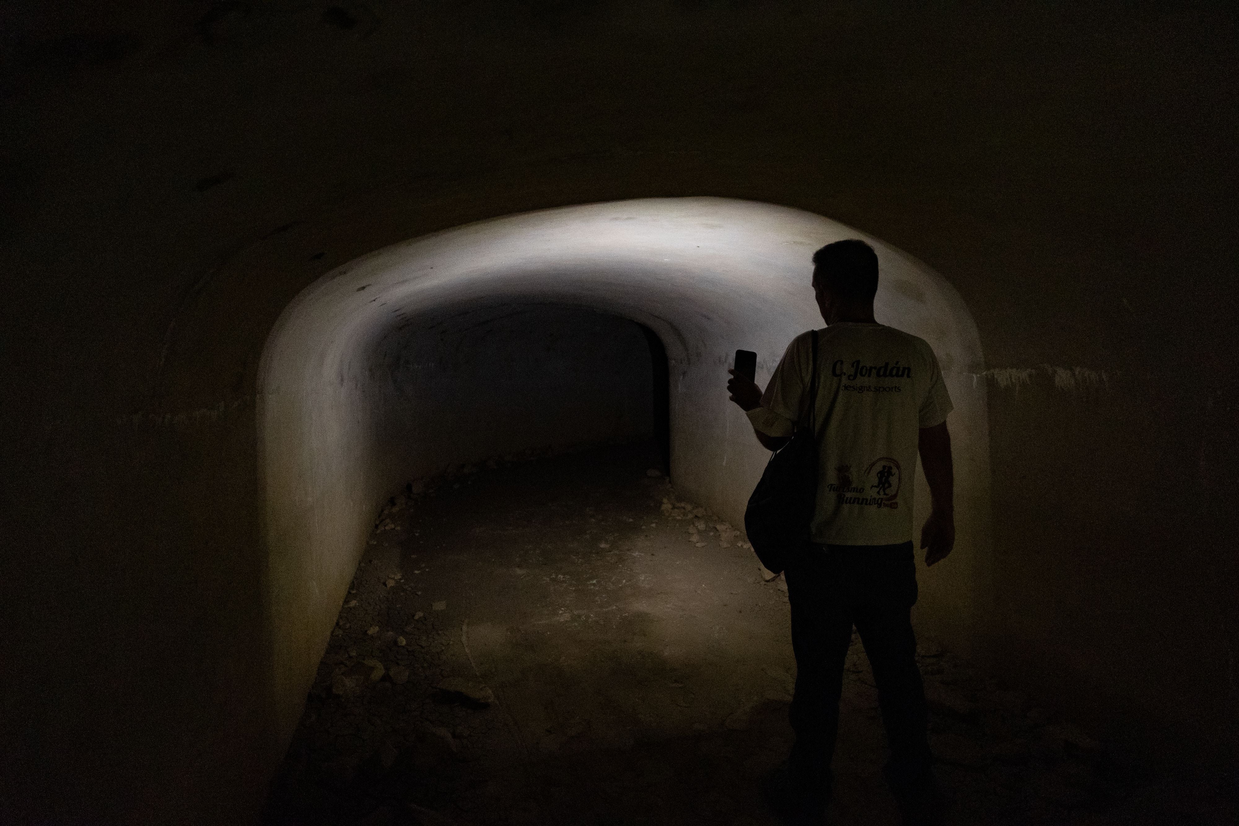 Carlos Jordán, from the San Roque tourism department, shines his flashlight on the tunnel that stretches around 500 meters under the Sierra Carbonera in La Línea de la Concepción.
