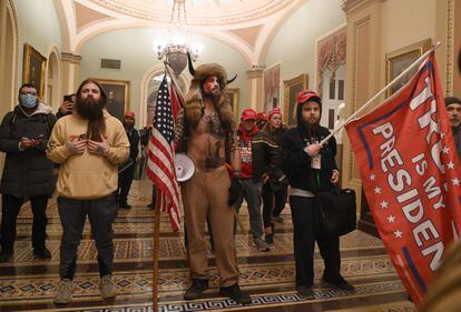 Supporters of Donald Trump (including Jake Angeli, known as the so-called 'QAnon Shaman' in the center), inside the Capitol.