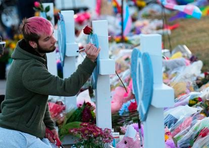 A person writes a message at the memorial for the victims of the attack on Club Q, in Colorado Springs, on November 19, 2022.