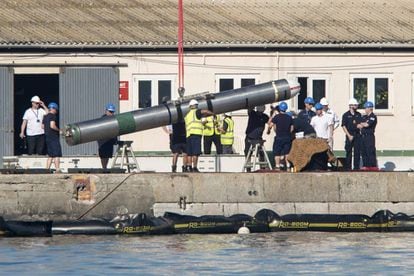 Technicians removing a missile from HMS Ambush in the port of Gibraltar.