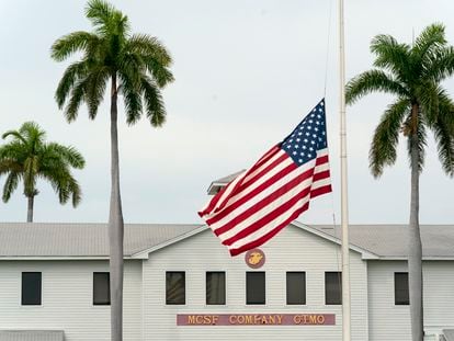In this photo reviewed by U.S. military officials, a flag flies at half-staff in honor of the U.S. service members and other victims killed in the terrorist attack in Kabul, Afghanistan, at Marine Corps Security Force Company, Aug. 27, 2021, in Guantanamo Bay Naval Base, Cuba.