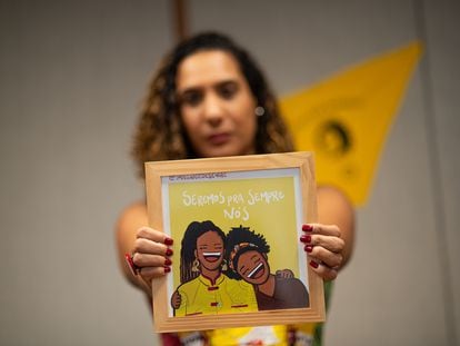 Anielle Franco, Brazil's ministrer for Racial Equality holds a portrait of herself and her sister, Marielle