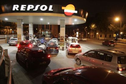 Drivers wait in line at a Repsol gas station.