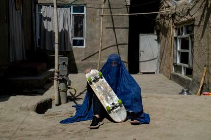 Women who practice sports in Afghanistan have received intimidating phone calls and visits from the Taliban. The Taliban believe playing sports goes against a woman's modesty and role in society. In this picture, an Afghan girl poses with her skateboard.
