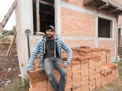 Daniel Escobedo oversees construction of a house funded by money sent from the US.
