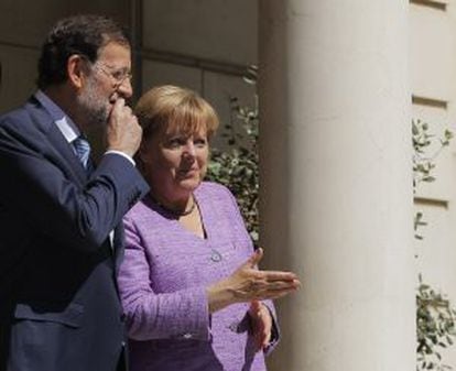 Spain&#039;s Prime Minister Mariano Rajoy, left, welcomes Germany&#039;s Chancellor Angela Merkel, right, during a meeting at the Moncloa Palace.
