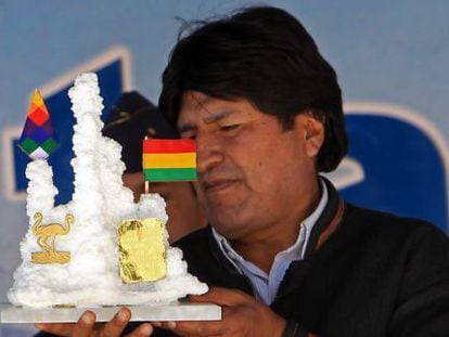 Evo Morales holds a present from a worker at a lithium plant.