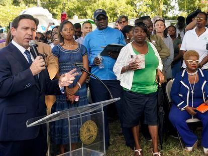 Florida Gov. Ron DeSantis, left, speaks at a prayer vigil for the victims of a mass shooting a day earlier, in Jacksonville, Florida, on Aug. 27, 2023.