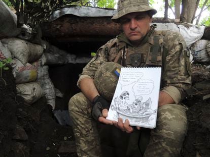 Ruslan Pikhota with one of his illustrations in a trench in Kharkiv province.