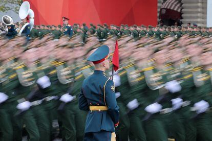 Russian service members march past an honor guard during a military parade on Victory Day.