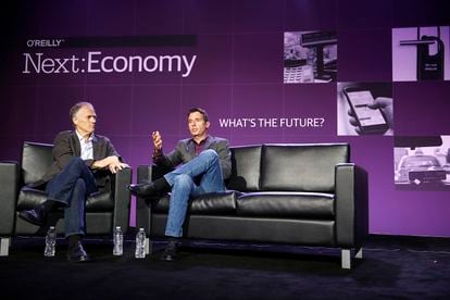 Tim O'Reilly (left) speaks with then Uber chief advisor and board member David Plouffe (middle) during the Next: Economy conference in San Francisco, California, in 2015.