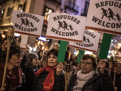 People in Barcelona march in support of refugees.