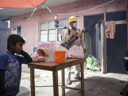 A sanitation worker fumigating a home in Oaxaca, Mexico.