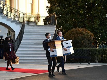 Employees carry boxes out of the White House on the last day of Donald Trump's term, January 20, 2021.