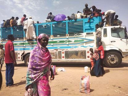 People board a truck as they leave Khartoum, Sudan, Monday, June 19, 2023.