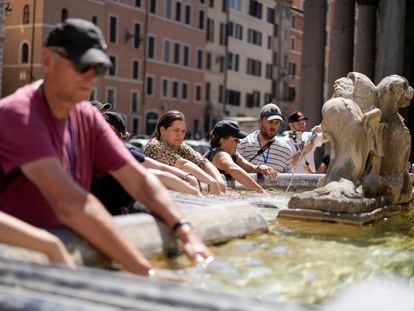 People cool off at a fountain in front of the Pantheon, in Rome, Saturday, Aug. 19, 2023, where temperatures were expected to reach as high as 37 Celsius (98 Farenheit).