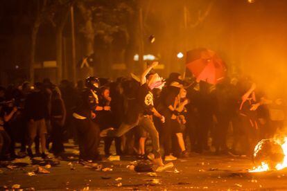 A protestor throws an object at police in Barcelona on Friday night.