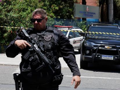 A Brazilian police officer on Monday outside the public school where a student opened fire on other students.