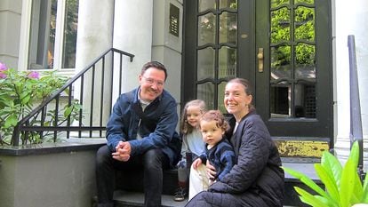 Victoria Campetella with her husband and children in front of their home in Hamburg.