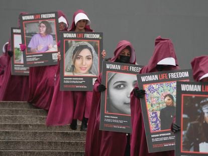 Activists hold placards reading "Woman, Life, Freedom" with portraits of women who were killed in Iran, during a demonstration to mark the International Women's Day, in London, on March 8, 2023.