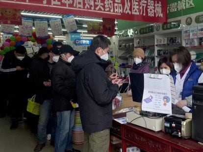 Shoppers buying medicine at a Beijing pharmacy in December.