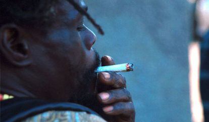 A young man smokes marijuana in Kingston, Jamaica.