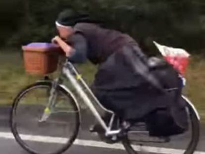 Video of Polish bride of Christ hunched behind her handlebars has quickly gone viral on social networks