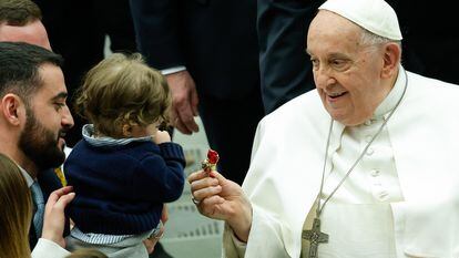 Pope Francis gives a sweet to a child during his weekly general audience in the Paul VI Hall, Vatican City, 28 February 2024.