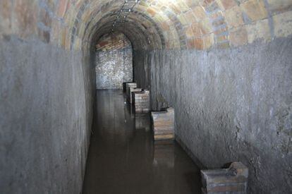One of the flooded tunnels. The supports for the benches that occupants used to sit on during the bombing raids are still visible.