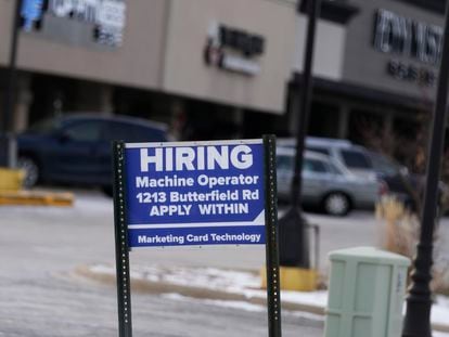 A hiring sign is seen in Downers Grove, Illinois, Thursday, May 5, 2022.
