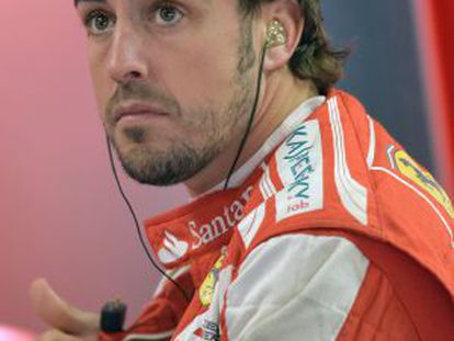 Fernando Alonso relaxes at the Ferrari pits at the Interlagos circuit on Friday.