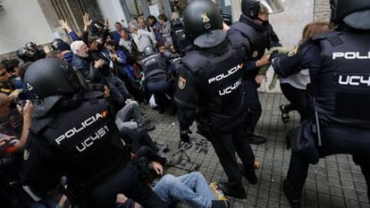 Police break up a group of voters on October 1 in Barcelona.