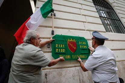 Two men preparing one of Rome's polling offices for Sunday's election.
