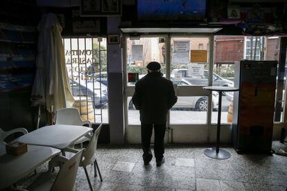 A patron of the Rincón de Toñín bar looks out the door. “Here there almost more bars than people,” jokes the owner.