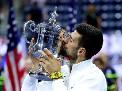 Serbia's Novak Djokovic celebrates with the trophy after winning the U.S. Open.