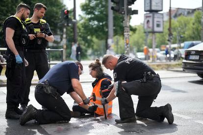 Police officers use hammers and chisels to remove a climate activist who has glued himself to a road during a climate protest in Berlin, Germany, on May 22, 2023. 

Associated Press/LaPresse
Only Italy and Spain