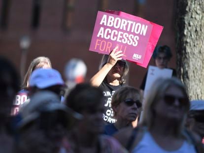 A woman holds a sign while joined by other supporters during an abortion rights rally in The People's Park in Annapolis, Maryland, on June 24, 2022.