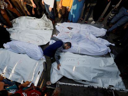 A man with the bodies of victims of an Israeli airstrike in Gaza during a funeral in Khan Younis on Tuesday.