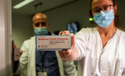 A health worker holds up a box of the Moderna vaccine in a hospital in Palma de Mallorca.