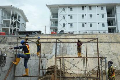 Workers build a metal structure at the construction site of the new capital city in Penajam Paser Utara, East Kalimantan, Indonesia, Wednesday, March 8, 2023.