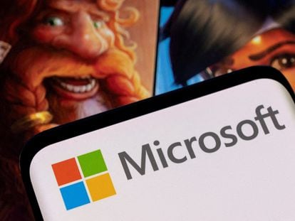Microsoft logo is seen on a smartphone placed on displayed Activision Blizzard's games characters in this illustration taken January 18, 2022.