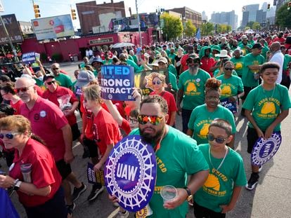 United Auto Workers members walk in the Labor Day parade in Detroit, Monday, Sept. 4, 2023.