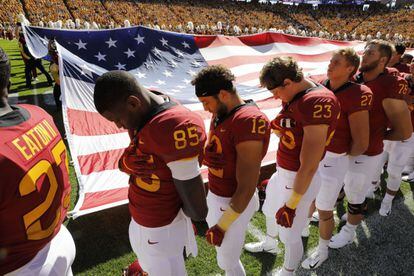 A minute of silence was held before the game in honor of Barquín. In this photo, members of the Cyclones team bow their heads as the Iowa State University band plays the national anthem.