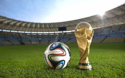 Adidas&#039; Brazuca ball and the World Cup trophy.