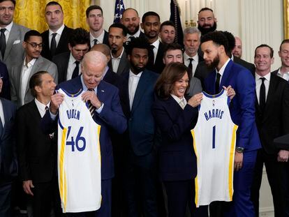 President Joe Biden and Vice President Kamala Harris hold up team jerseys as they welcome the 2022 NBA champions, the Golden State Warriors, to the East Room of the White House in Washington, Tuesday, Jan 17, 2023.