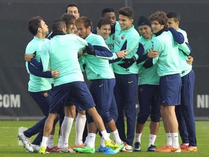 Barcelona players joke at a training session as Leo Messi (center) returns to the squad. 