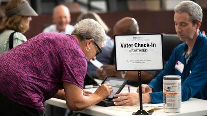 A poll worker prepares to give a ballot to a voter at Blue Ash, Ohio, on August 2, 2022.
