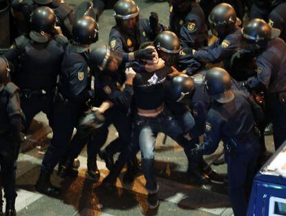Riot police detain a protester during the protests in Madrid on Tuesday night.