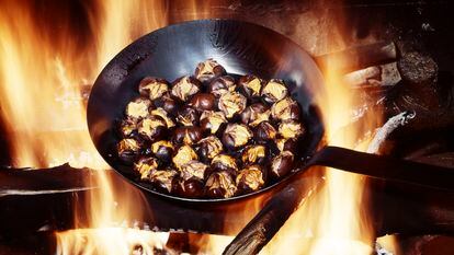 Chestnuts roasting in a cast-iron skillet.