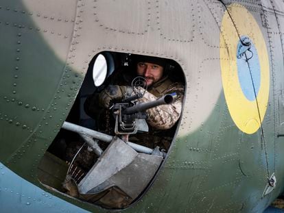 A Ukrainian serviceman of 12 aviation brigade sits inside a Mi-8 combat helicopter before flight during a combat mission in Kharkiv region, Ukraine, April 2, 2023.